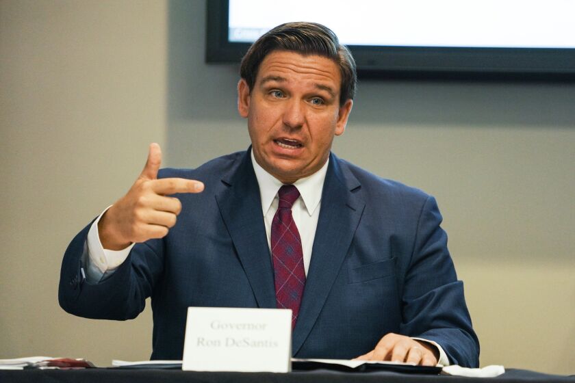 Florida Gov. Ron DeSantis answers questions during a roundtable discussion held alongside First Lady Casey DeSantis, regarding mental health and COVID-19 at the Tampa Bay Crisis Center on Thursday, July 16, 2020 in Tampa. (Martha Asencio-Rhine/Tampa Bay Times via AP)