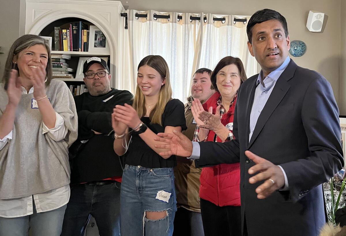 Rep. Ro Khanna speaks to a gathering of Biden supporters and press at a home.