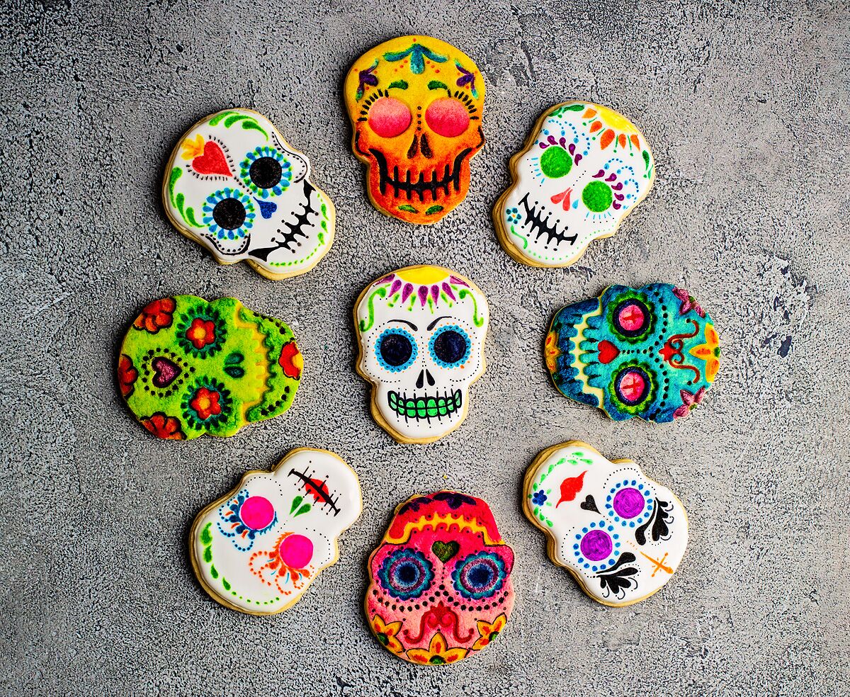Cookies in the shape of skulls colorfully painted for Dia de los Muertos.