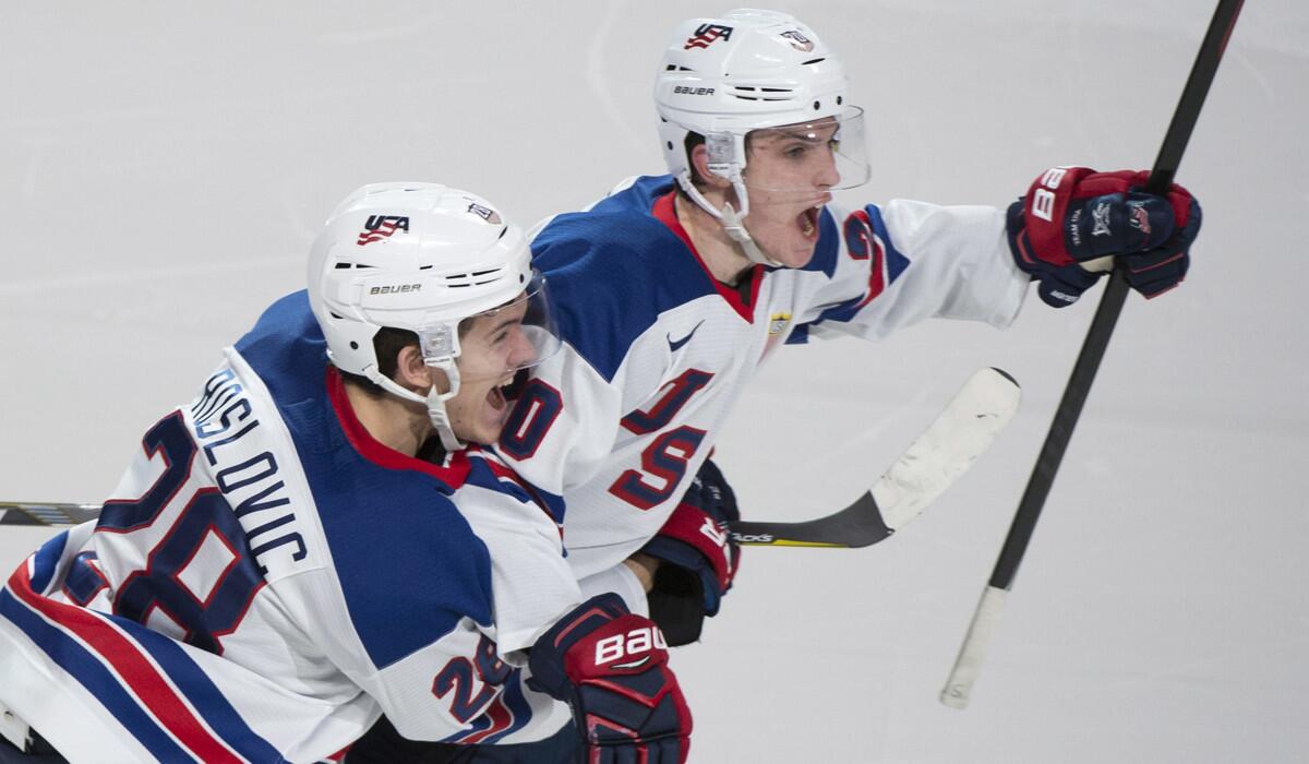 United States' Troy Terry, right, celebrates with teammate Jack Roslovic after scoring in the shootout to beat Russia 4-3 in a semifinal game at the World Junior ice hockey championships Wednesday.