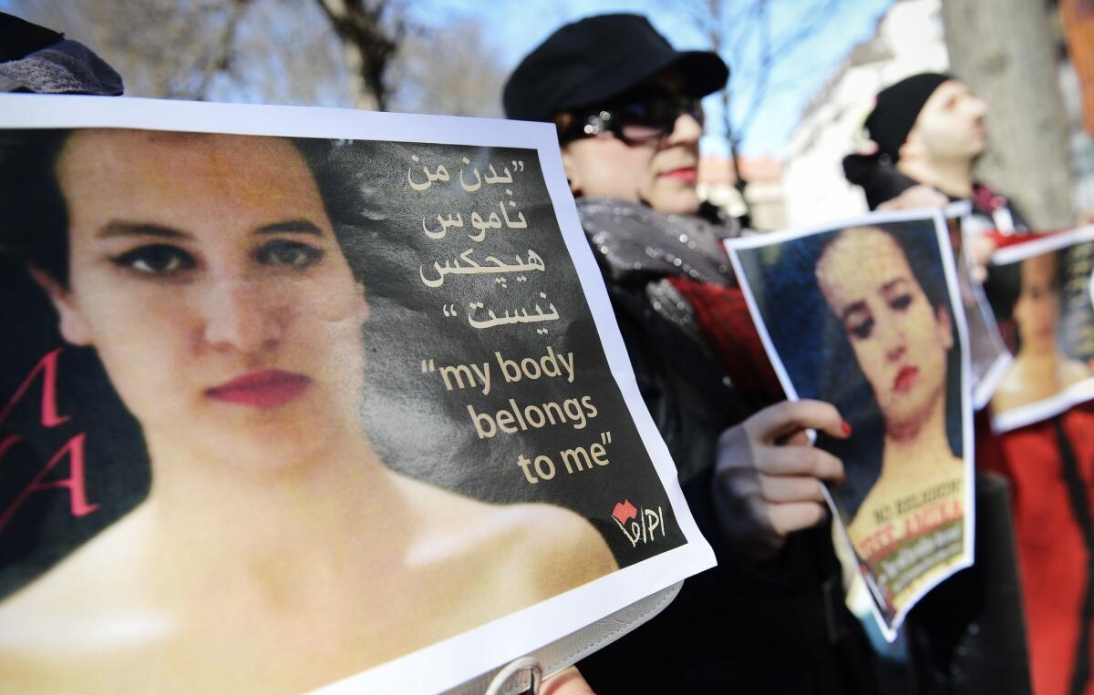 Activists hold images of Amina Tyler on April 4 as they take part in a protest outside the Tunisian Embassy in Stockholm.