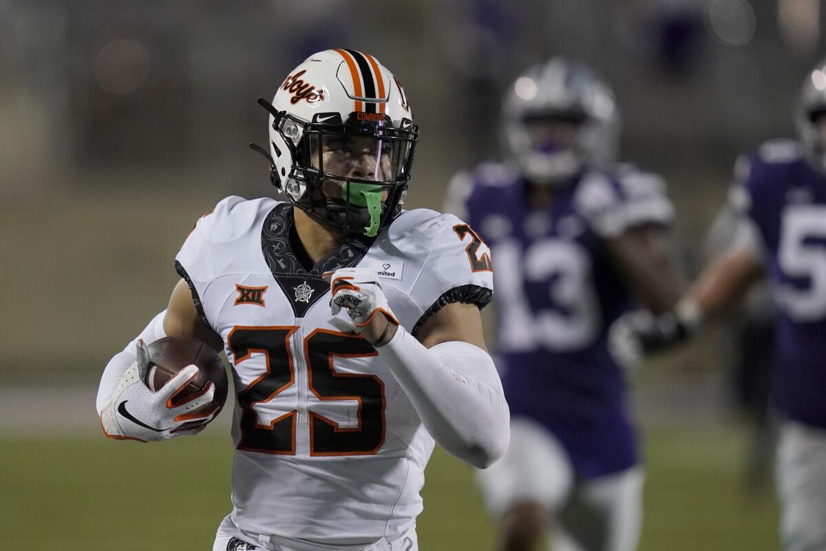 Oklahoma State safety Jason Taylor II takes a recovered fumble 85 yards for a touchdown Nov. 7, 2020.