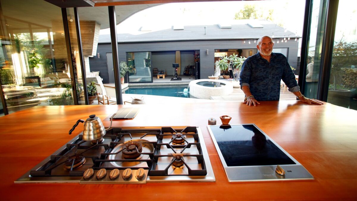 VENICE, CA - NOVEMBER 1, 2016 - Paul Hibler stands next to one of two wooden islands that features a built in stove in the kitchen of his home in Venice on November 1, 2016. (Genaro Molina / Los Angeles Times)