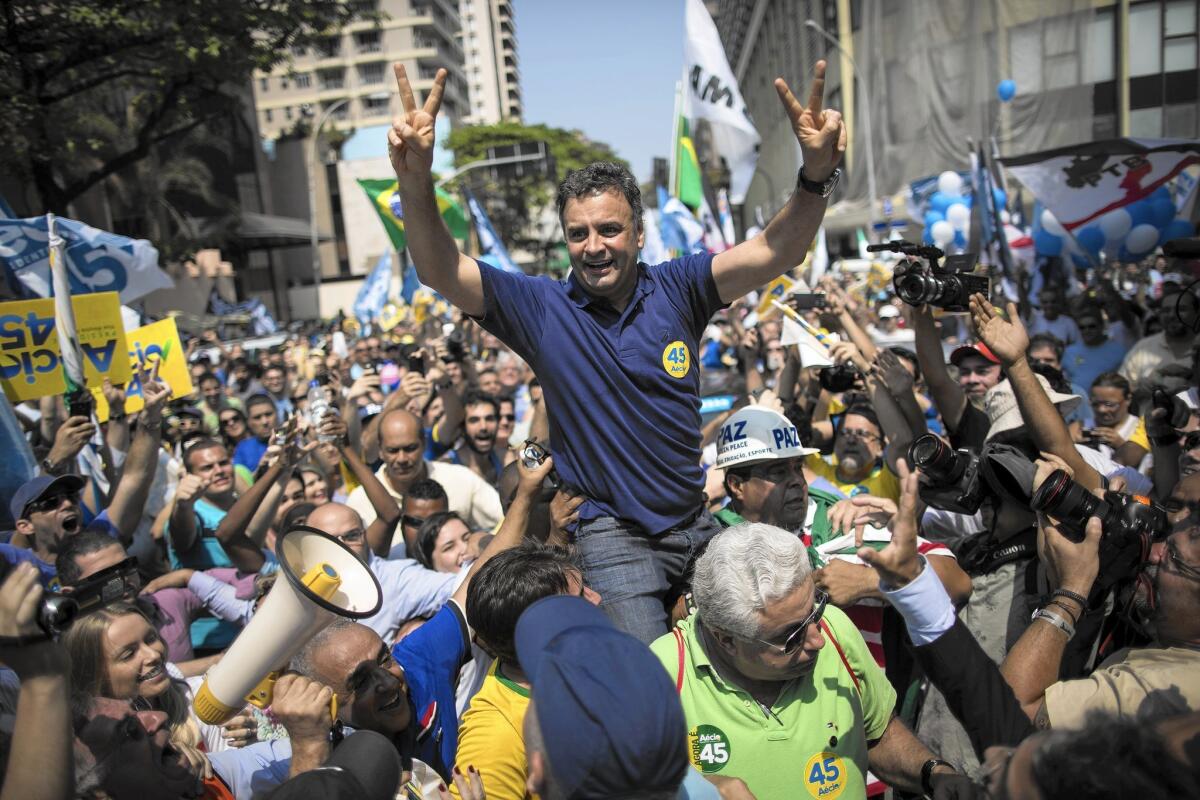 Presidential candidate Aecio Neves campaigns at Rio De Janeiro's Copacabana on Oct. 19. He has criticized President Dilma Rousseff over the Petrobras corruption scandal.