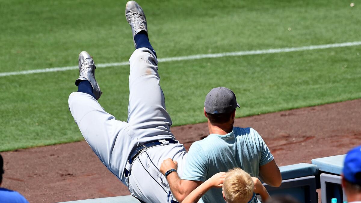 Rays first baseman Logan Morrison tumbles into the seats after catching a pop up by Howie Kendrick in the seventh inning Wednesday.