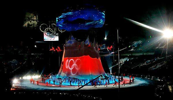 Skiers and snowboarders fly around a mountain as rollerbladers skate on the ground during the opening ceremony at BC Place in Vancouver, Canada.