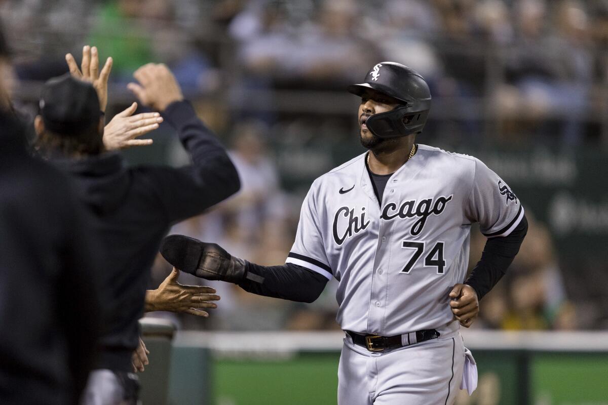 Chicago White Sox's Eloy Jimenez celebrates scoring against the Oakland Athletics during the fifth inning of a baseball game in Oakland, Calif., Tuesday, Sept. 7, 2021. (AP Photo/John Hefti)