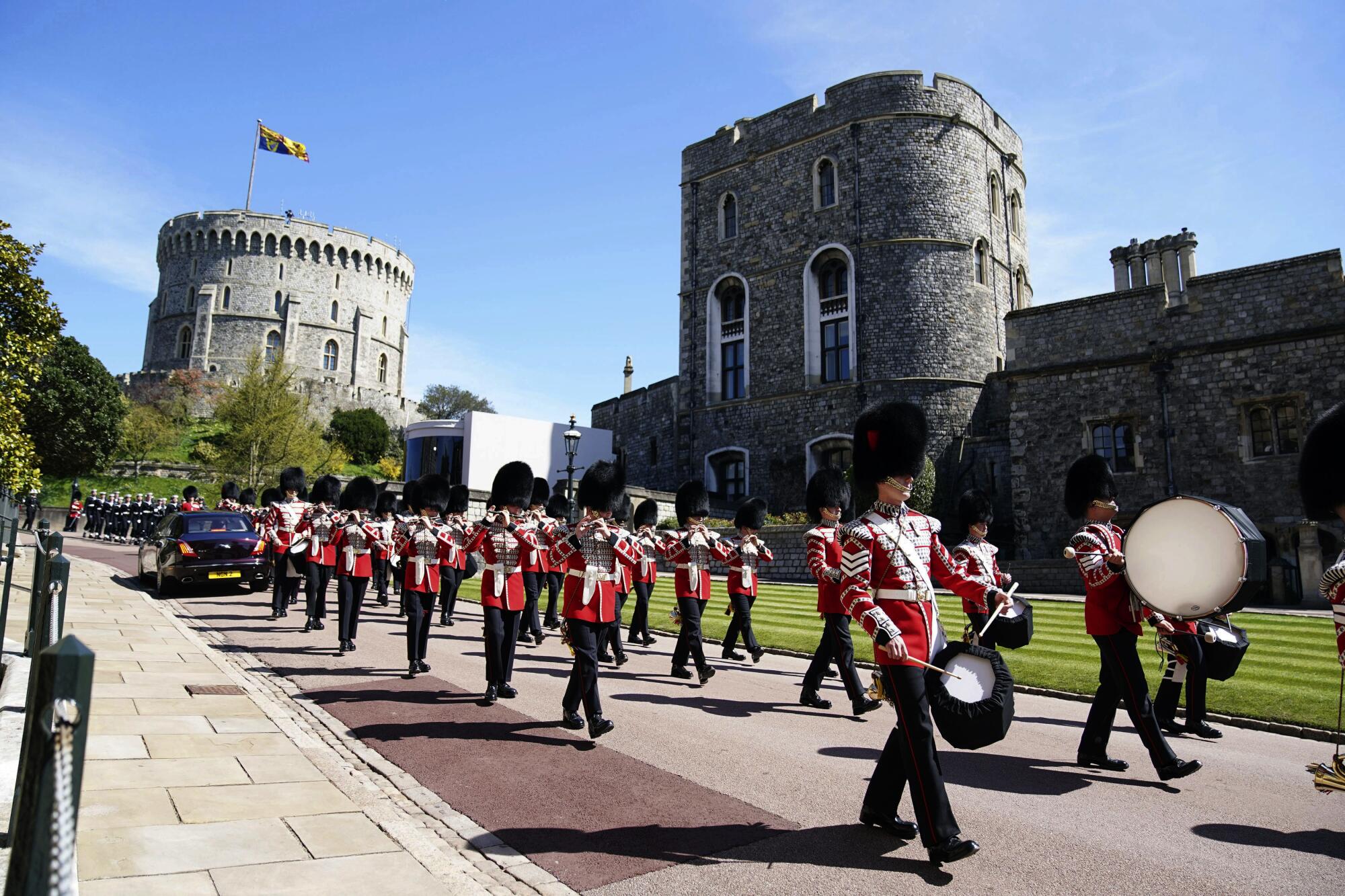 Members of the military march and play instruments outside Windsor Castle.