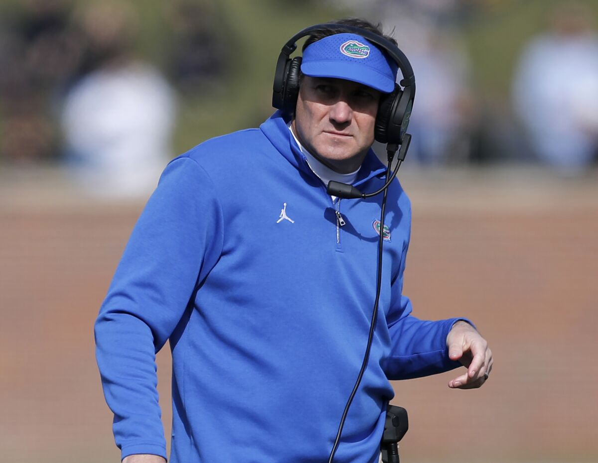FILE - In this Nov. 16, 2019, file photo, Florida head coach Dan Mullen watches from the sideline during the first half of an NCAA college football game against Missouri in Columbia, Mo. Mullen had several players miss the team’s opening training camp practice Monday, Aug. 17, 2020. (AP Photo/Jeff Roberson, File)