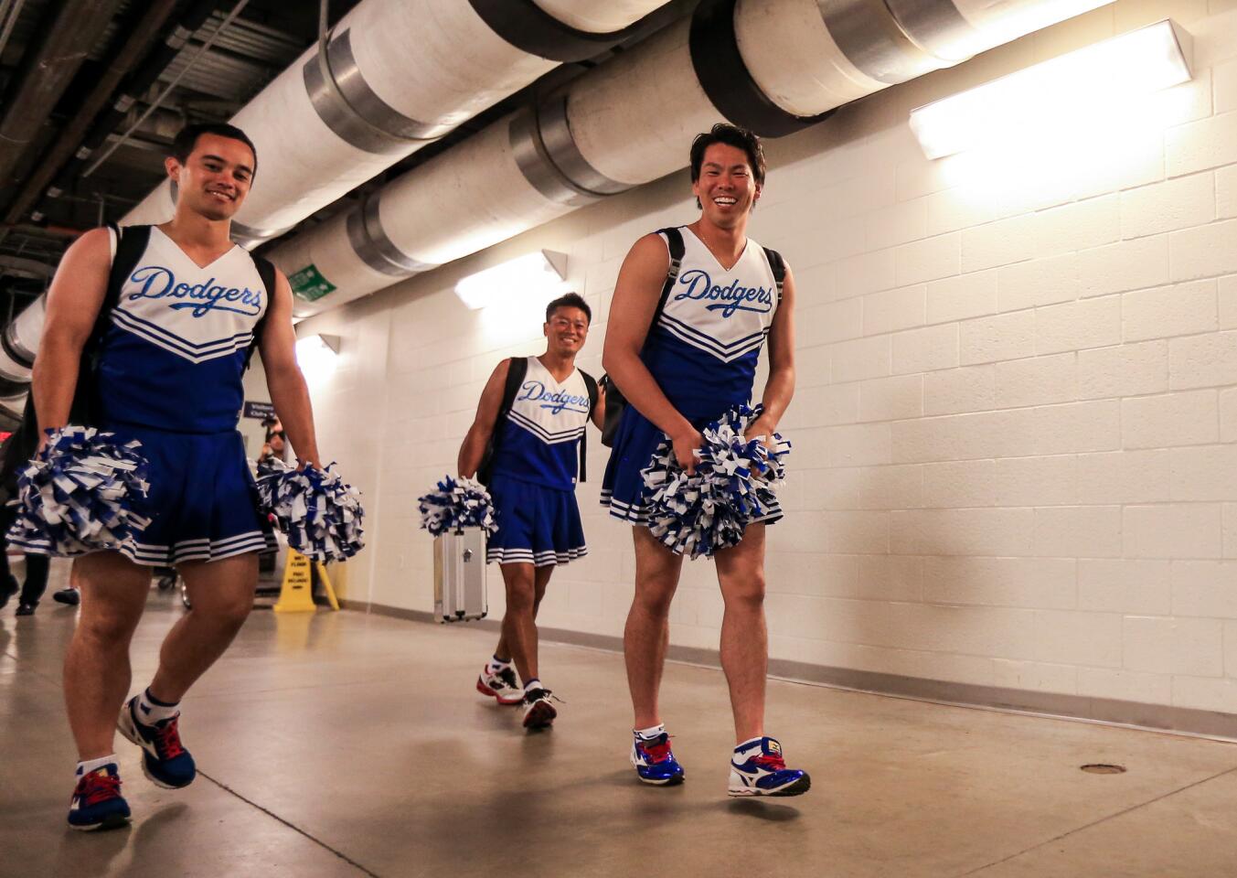 MIAMI, FL - SEPTEMBER 11: Kenta Maeda (R) of the Los Angeles Dodgers walks through the hallway at Marlins Park flanked by his translator (far L) and trainer (C) after the game against the Miami Marlins on September 11, 2016 in Miami, Florida. (Photo by Rob Foldy/Getty Images) ** OUTS - ELSENT, FPG, CM - OUTS * NM, PH, VA if sourced by CT, LA or MoD **