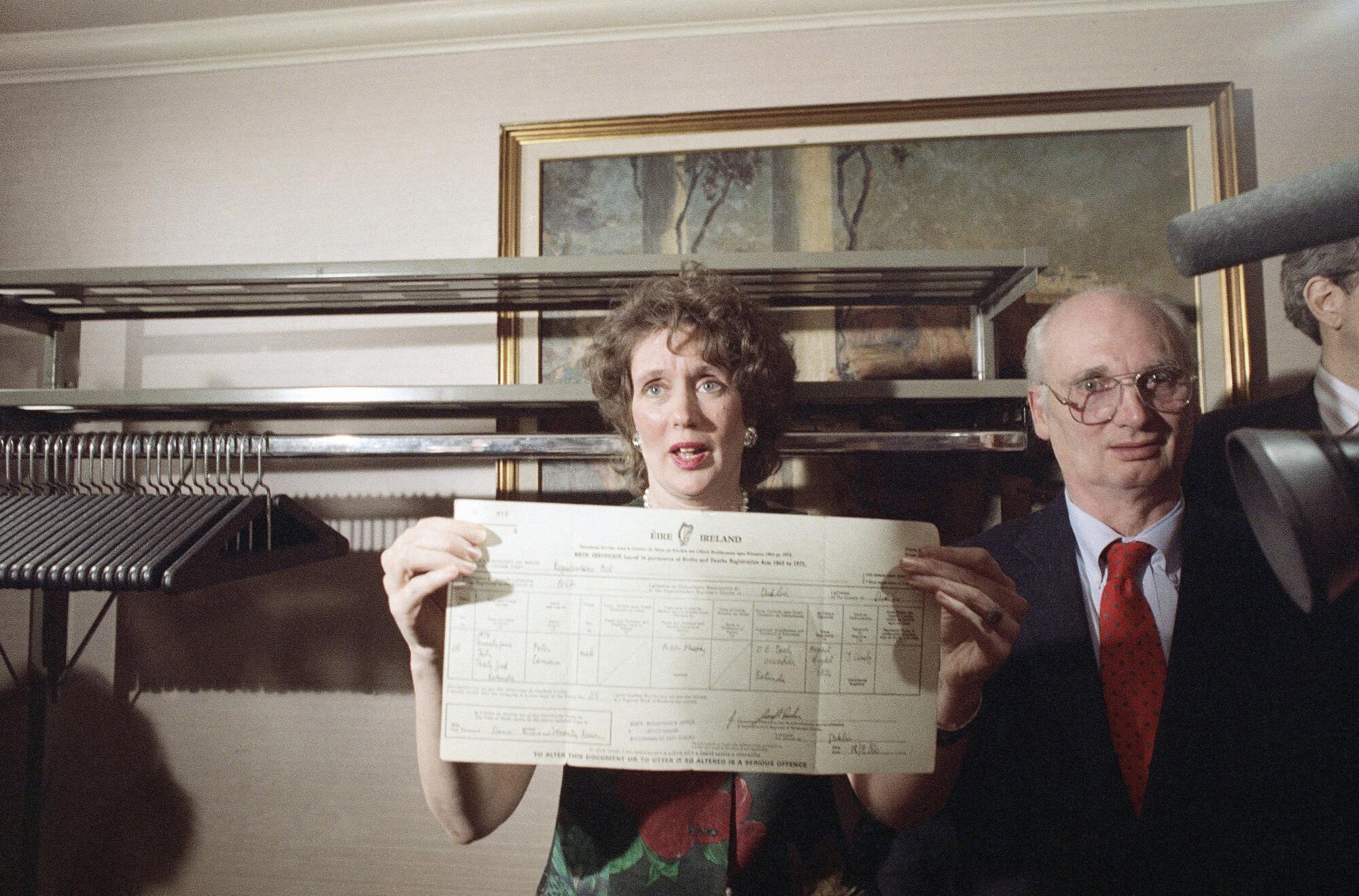 Annie Murphy holds up her son's birth certificate.