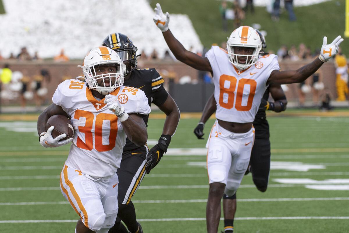 Tennessee running back Marcus Pierce Jr., left, scores a touchdown in front of teammate Ramel Keyton, right, during the second half of an NCAA college football game against Missouri Saturday, Oct. 2, 2021, in Columbia, Mo. Tennessee won 62-24. (AP Photo/L.G. Patterson)