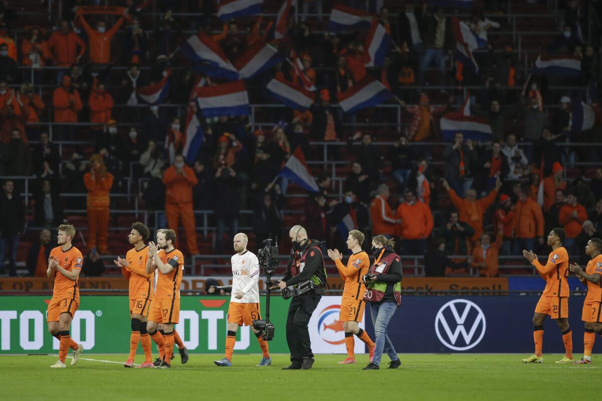 Netherlands' players cheer supporters at the end of the World Cup 2022 group G qualifying soccer match between The Netherlands and Latvia at the Johan Cruyff ArenA in Amsterdam, Netherlands, Saturday, March 27, 2021. Netherlands won 2-0. (AP Photo/Peter Dejong)