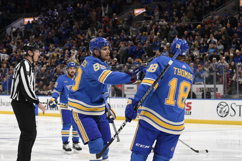 The Blues' Pavel Buchnevich (89) celebrates with Robert Thomas (18) after scoring a goal against the Ducks on Nov. 19, 2022.