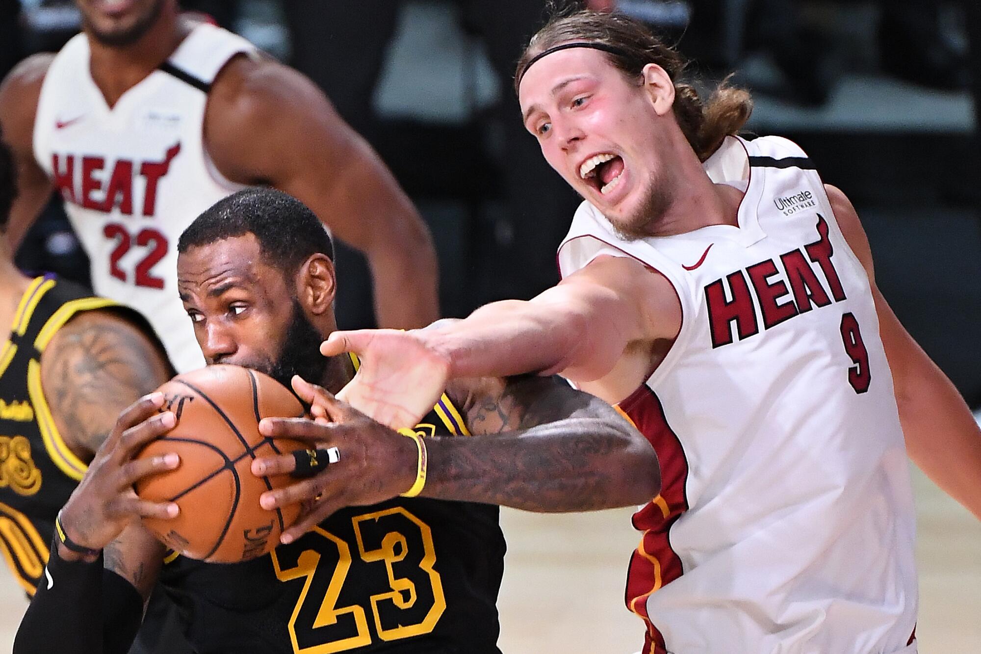 Lakers star LeBron James grabs a rebound in front of Miami's Kelly Olynyk during the second quarter of Game 2.