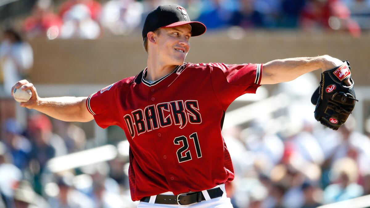 Diamondbacks starter Zack Greinke delivers a pitch against the Athletics during his spring debut on Friday.