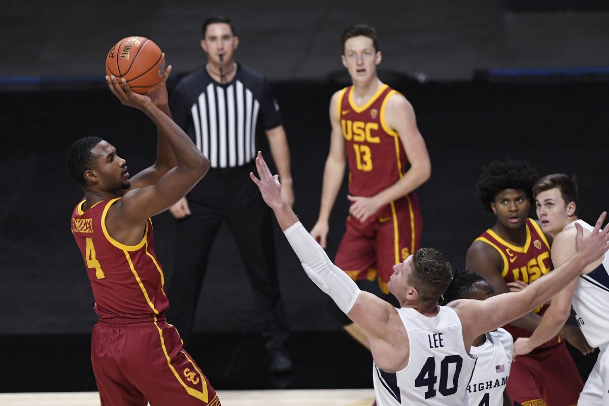 Southern California's Evan Mobley, left, shoots over BYU's Kolby Lee in the first half.