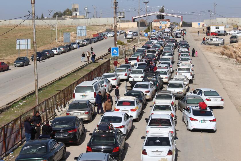 AR RAMTHA, JORDAN - JANUARY 16: Jordanian drivers wait in queue due to the rigid practices at the Jaber- Naseeb crossing between Jordan and Syria reopened on 15th of October, 2018 after being closed for three years in Ar-Ramtha, Jordan on January 16, 2019. The reopening of the border promises to boost Jordan's ailing economy. (Photo by Laith Joneidi/Anadolu Agency/Getty Images)