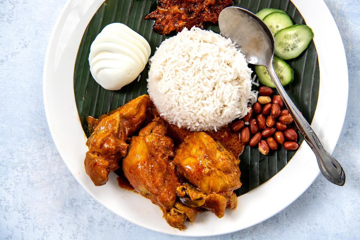 An overhead photo of Nasi lemak with chicken curry from Ipoh Kopitiam.