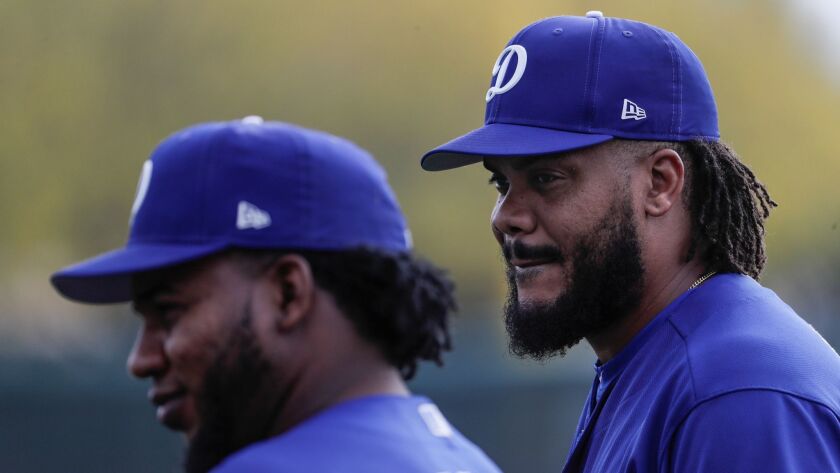 Dodgers pitchers Kenley Jansen, right, and Javier Baez during a spring training workout at the Camelback Ranch complex.
