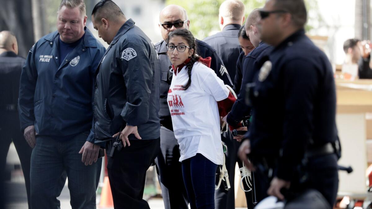 Police detain a street vending protester who refused to leave after a dispersal order.