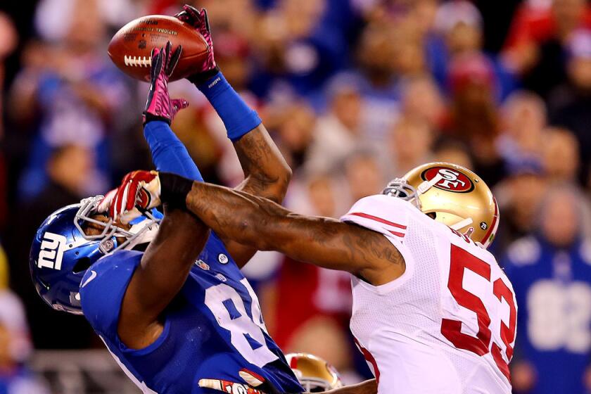 New York Giants' Larry Donnell, left, makes the catch for the game-winning touchdown as San Francisco 49ers' NaVorro Bowman defends in the fourth quarter on Sunday.