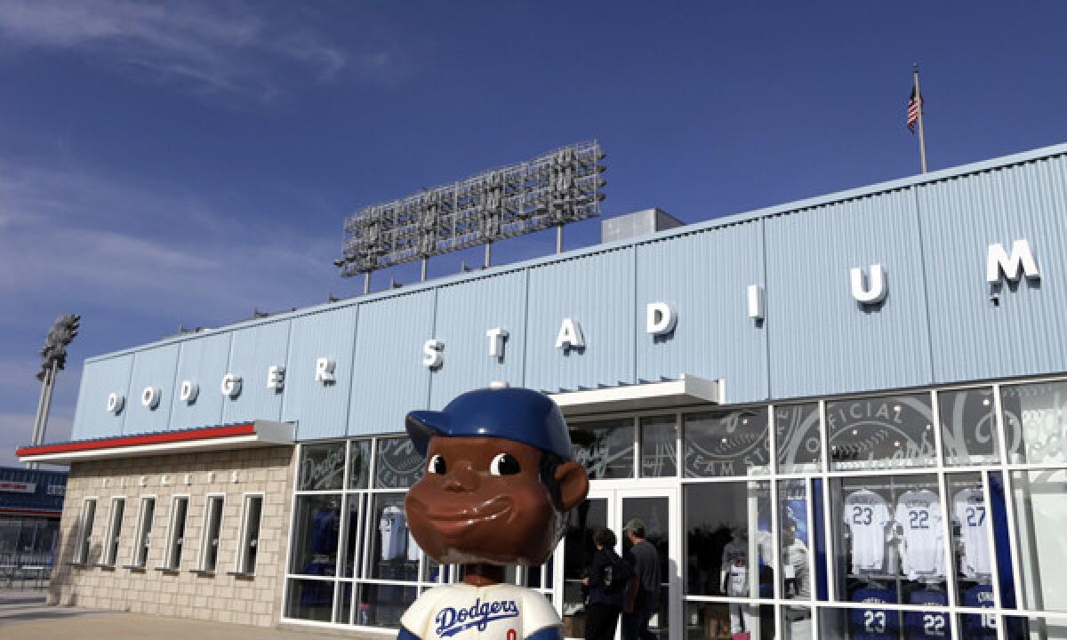A bobblehead statue sits on display in front of the reserve level entrance at Dodger Stadium in March. Major League Baseball is requiring teams to implement new security rules in 2015.