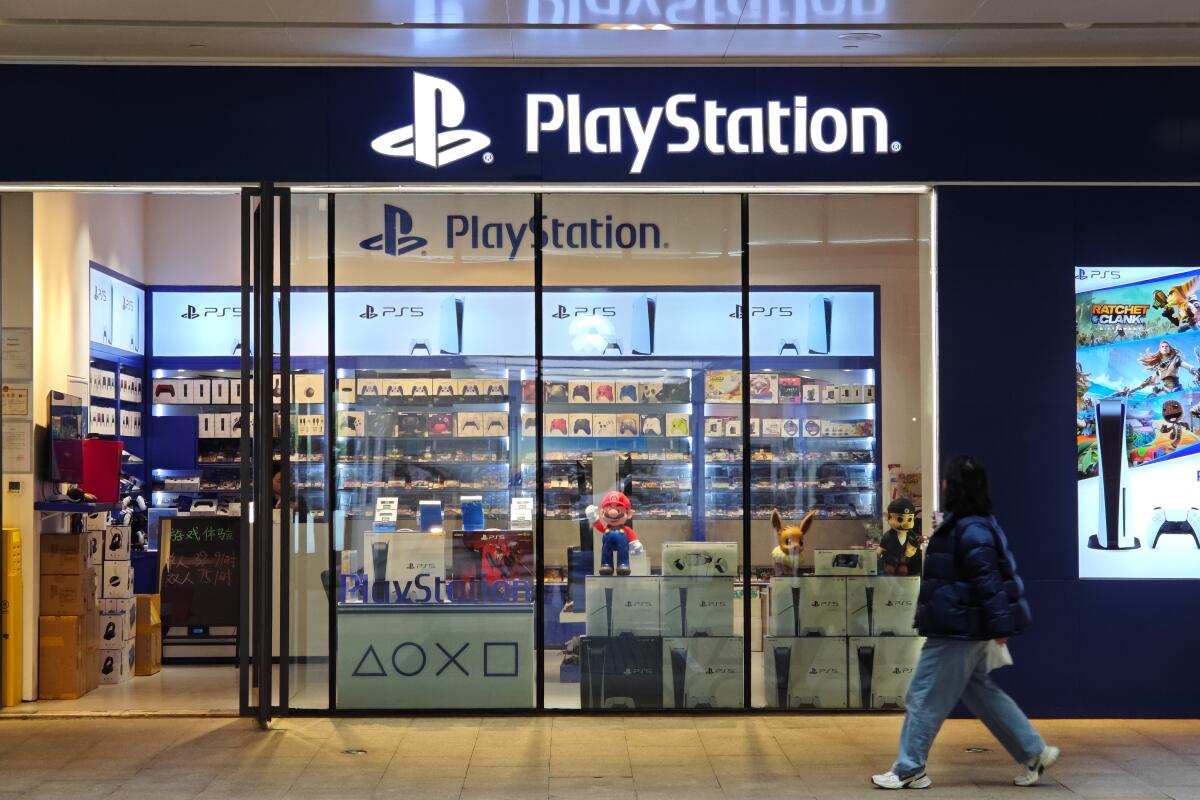 A pedestrian passes a Sony PlayStation game-console store in a mall in Shanghai 