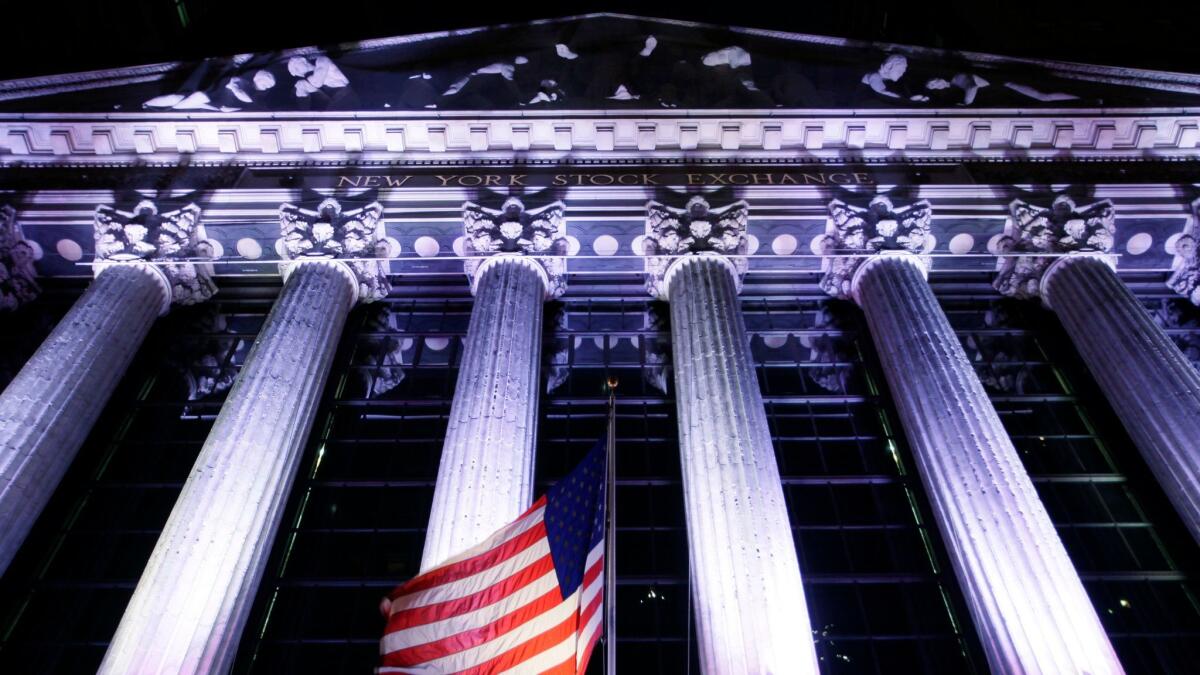 An American flag flies in front of the New York Stock Exchange. The benchmark Standard & Poor’s 500 index has gained about 47% since February 2016.