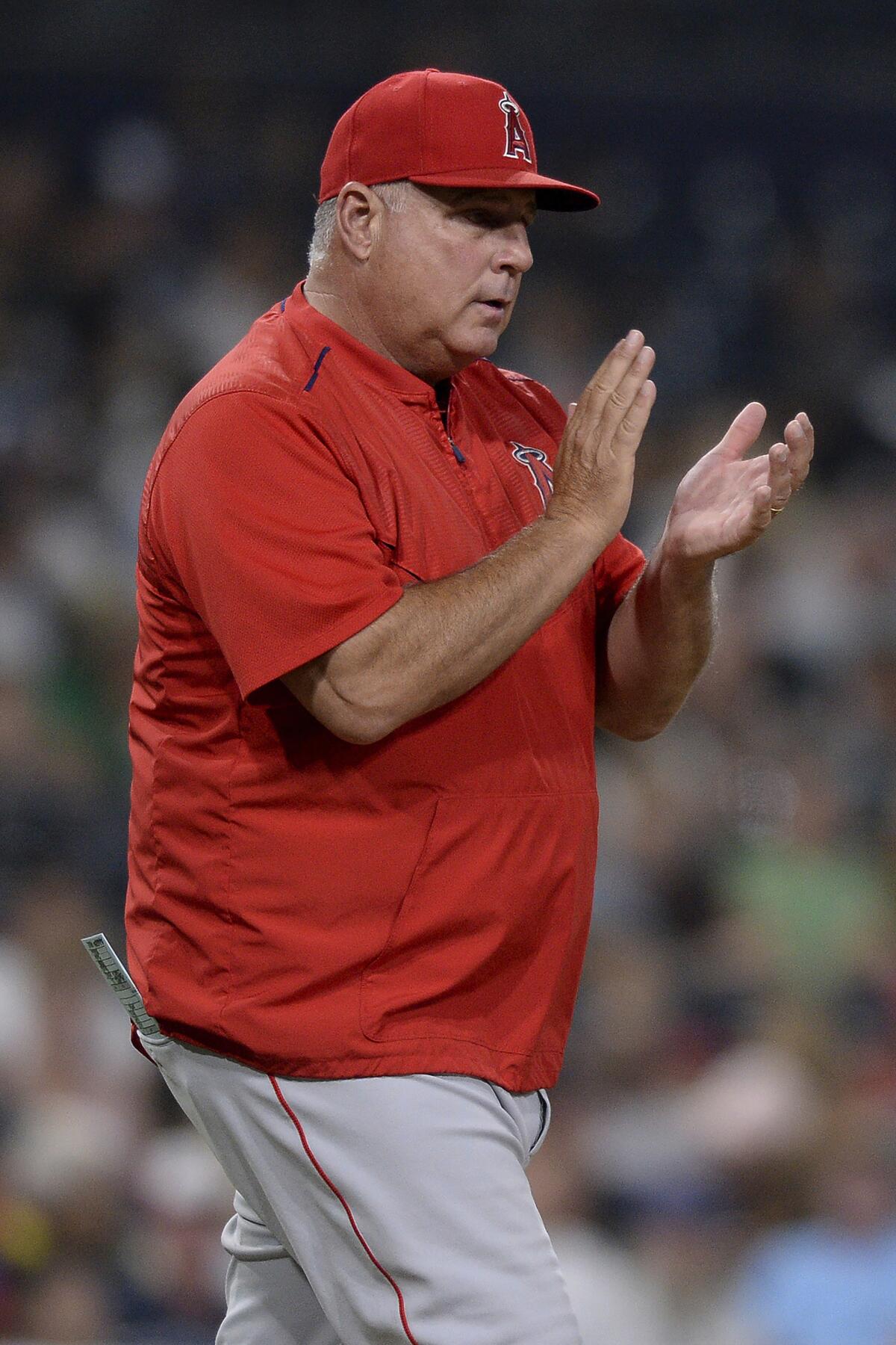 FILE - Los Angeles Angels' Mike Scioscia walks to the mound during the sixth inning of a baseball game against the San Diego Padres, Tuesday, Aug. 14, 2018, in San Diego. Former Dodgers catcher Mike Scioscia will manage the National League team of prospects and retired shortstop Jimmy Rollins will lead the American League group at the All-Star Futures Game in Los Angeles on July 17. (AP Photo/Orlando Ramirez)