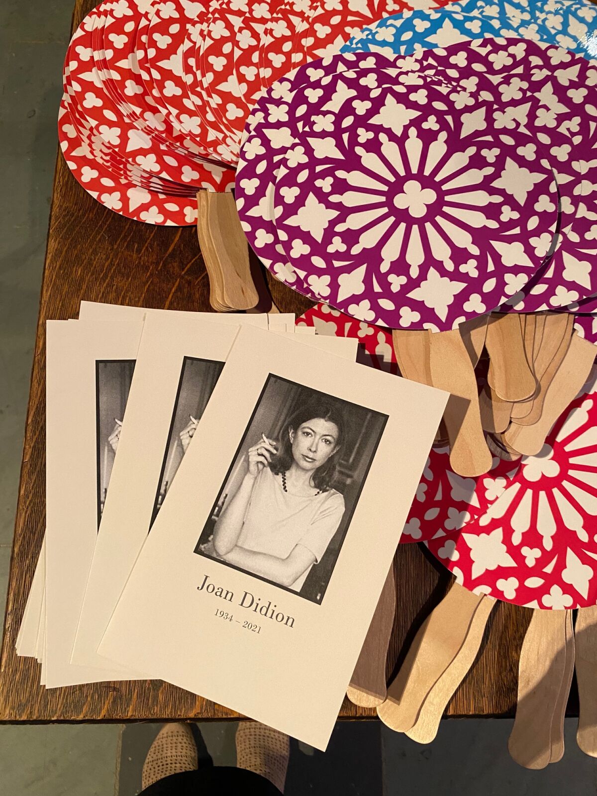 An assortment of programs and hand fans at Wednesday's memorial tribute to Joan Didion in New York.
