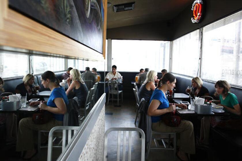 CASUAL: The interior of Blue Star offers a simple dining room with windows looking out to the patio.