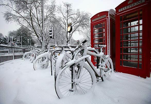 Snow covers bikes outside the Queensway subway station in London. The United Kingdom is enduring its heaviest snowfall since the 1990s. The heavy snow has disrupted many parts of the London transportation system, and hundreds of schools have been forced to close.