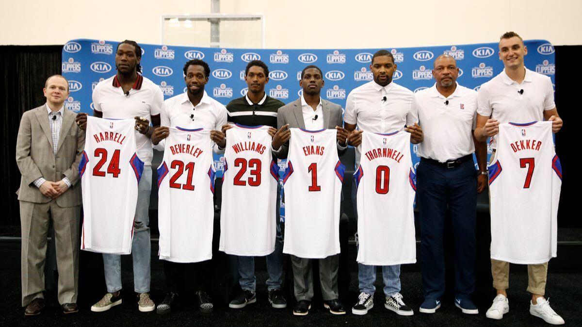 From left, Clippers executive vice president of basketball operations Lawrence Frank, Montrezl Harrell, Patrick Beverley, Lou Williams, Jawun Evans, Sindarius Thornwell, coach Doc Rivers and Sam Dekker.