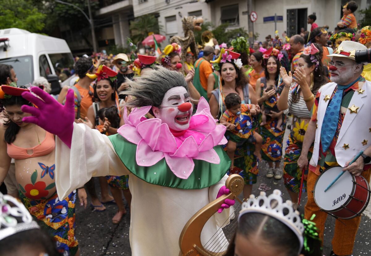 A clown walks among revelers at the "Gigantes da Lira" street block party in Rio de Janeiro on Feb. 12.