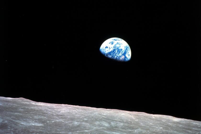 FILE - This Dec. 24, 1968, file photo made available by NASA shows the Earth behind the surface of the moon during the Apollo 8 mission. Retired Maj. Gen. William Anders, the former Apollo 8 astronaut who took the iconic “Earthrise” photo showing the planet as a shadowed blue marble from space in 1968, was killed Friday, June 7, 2024, when the plane he was piloting alone plummeted into the waters off the San Juan Islands in Washington state. He was 90. (William Anders/NASA via AP, File)