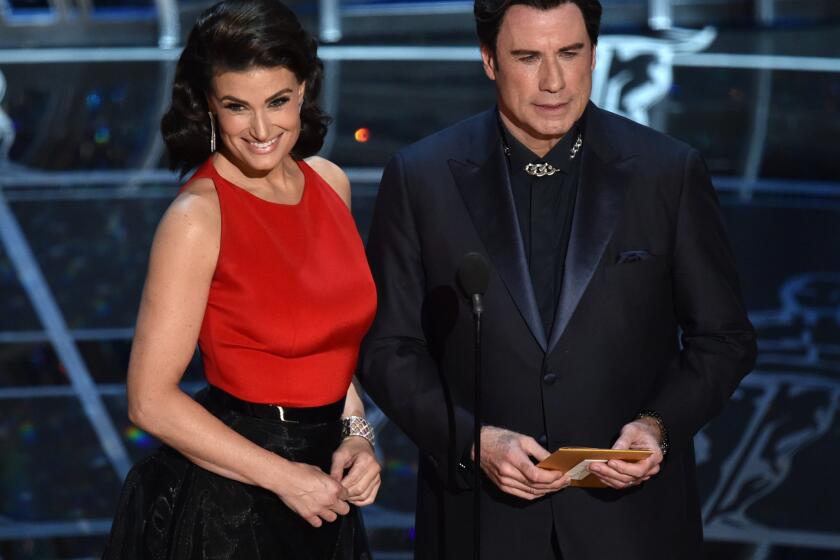 Idina Menzel and John Travolta present the Oscar for original song.