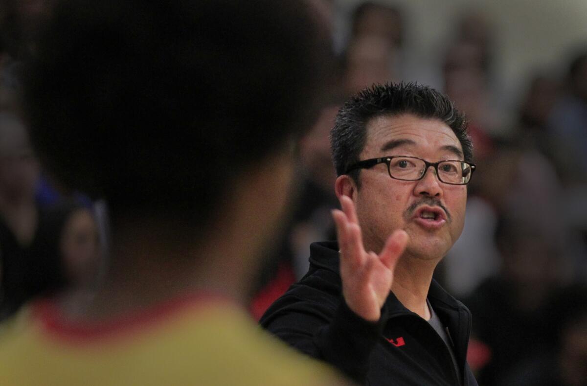 Fairfax Coach Harvey Kitani gives instruction to one of his player during a Western League game against Westchester.