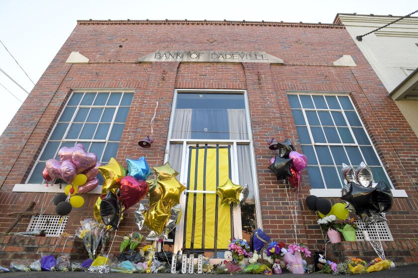 A makeshift memorial is created at the scene of the fatal shooting at a dance studio in Dadeville, Ala., Wednesday April 19, 2023. Two teenagers have been arrested and charged with murder in connection with the shooting that killed four young people at a Sweet Sixteen birthday party, investigators announced Wednesday. (Mickey Welsh/The Montgomery Advertiser via AP)