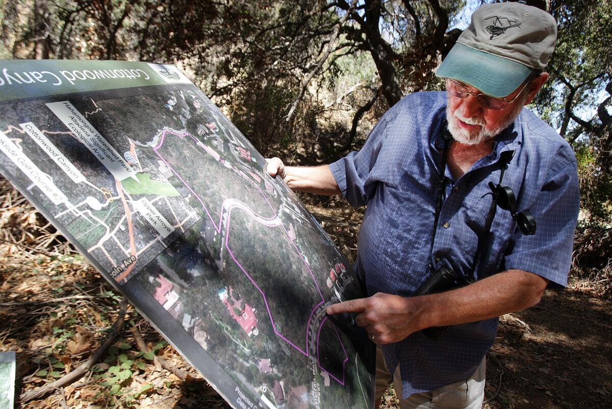 Biologist Mickey Long, advisor for the Arroyos & Foothills Conservancy, shows a map of Cottonwood Canyon in Pasadena on Tuesday, September 23, 2014. The Arroyos & Foothills Conservancy hopes to acquire the property to protect it as a wildlife corridor.