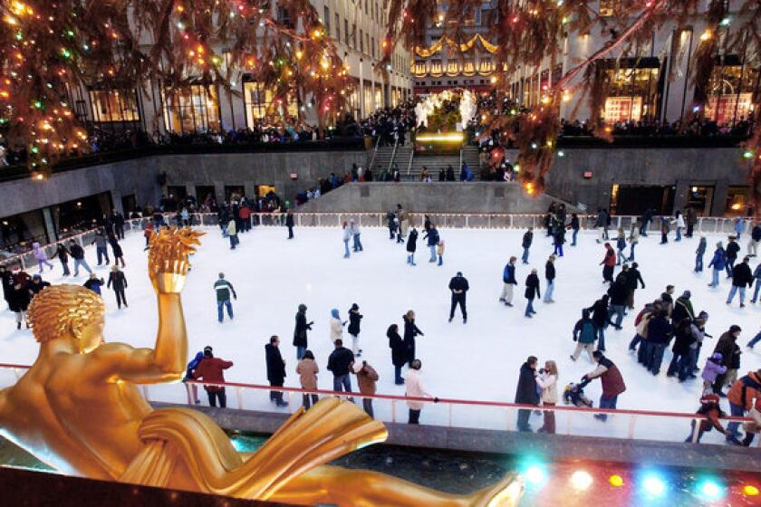 Lights twinkle and staters circle the Rockefeller Center ice skating rink. Rockefeller Center is one of many sites that On Location Tours will pass on a seasonal bus outings focusing on Manhattan holiday displays and film locations. This scene was shot in 2003.