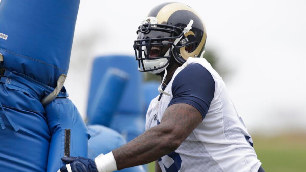 Rams nose tackle Michael Brockers blows past a block dummy during a practice on June 1.