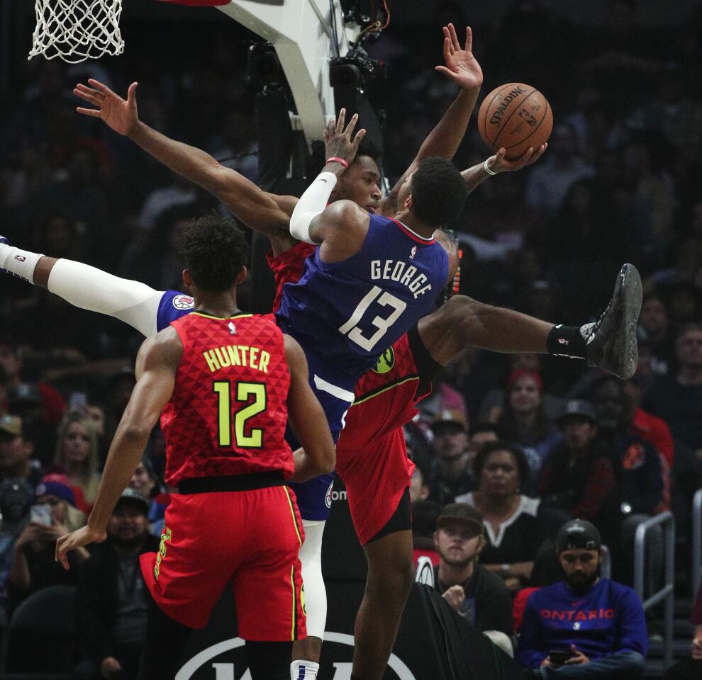 Clippers forward Paul George is fouled by Atlanta Hawks center Damian Jones.