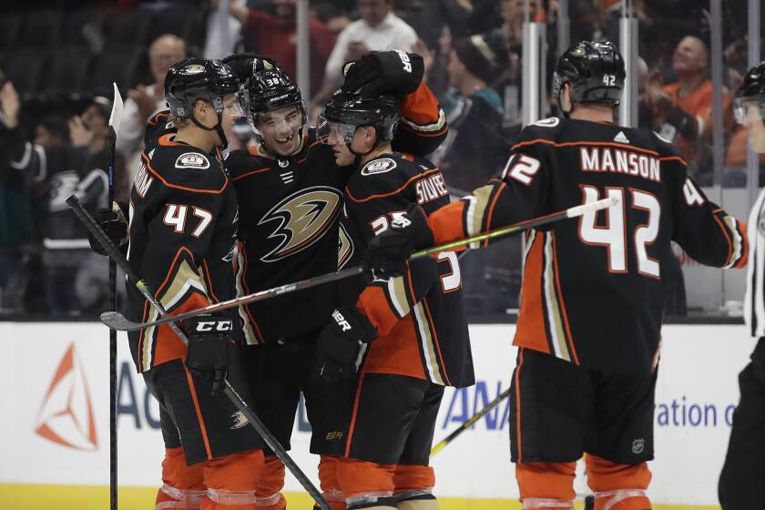 Ducks' Jakob Silfverberg, second from right, is hugged by teammates after scoring against the Buffalo Sabres during the third period on Wednesday, Oct. 16, 2019, in Anaheim, Calif. (AP Photo/Marcio Jose Sanchez)