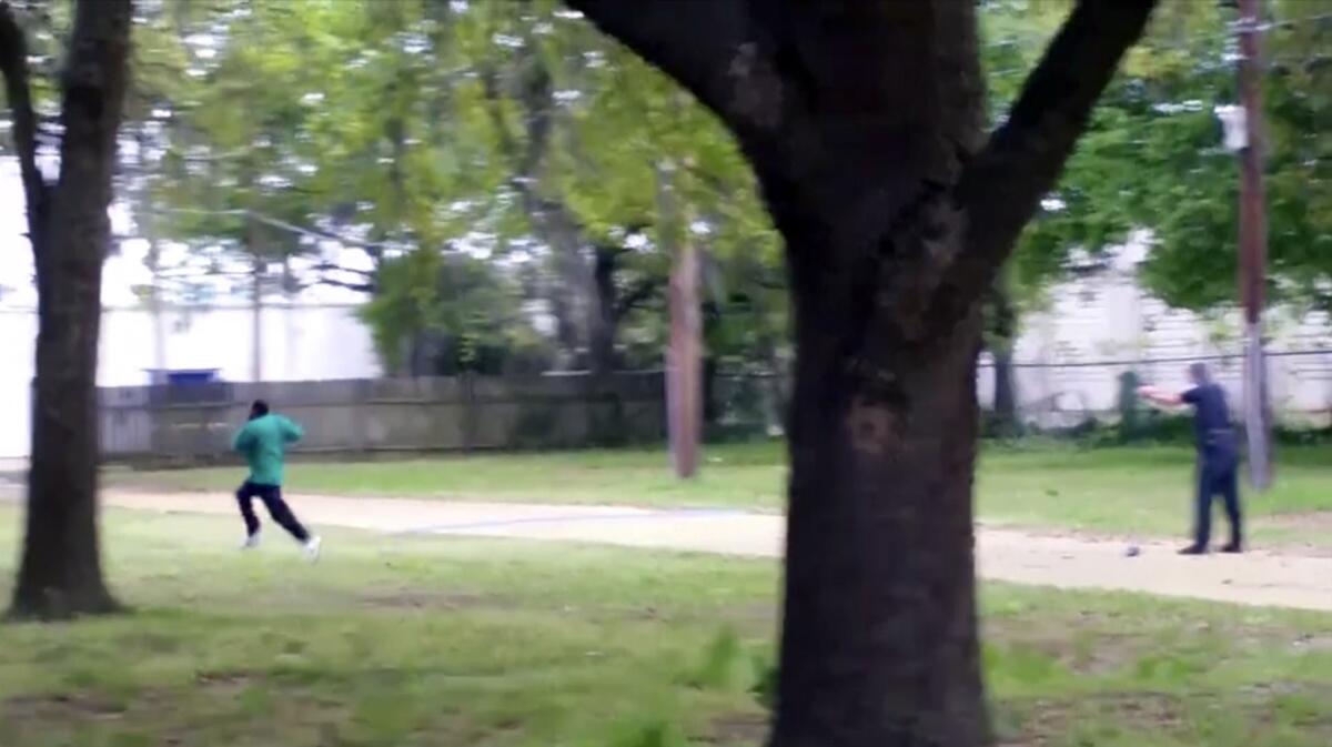 In this April 4, 2015, image from video, Walter Scott, left, runs as North Charleston Police Officer Michael Thomas Slager fires his weapon.