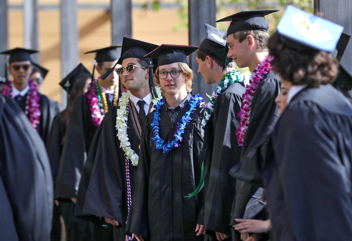 Students await taking the stage during the minutes before the 2023 Sage Hill graduation ceremony on Friday.