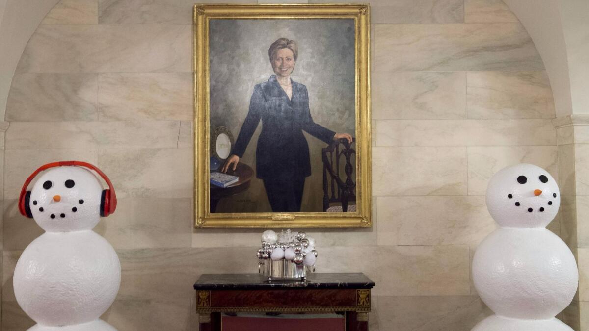 A portrait of former Secretary of State and First Lady Hillary Clinton hangs between snowmen in the Center Hall of the White House.