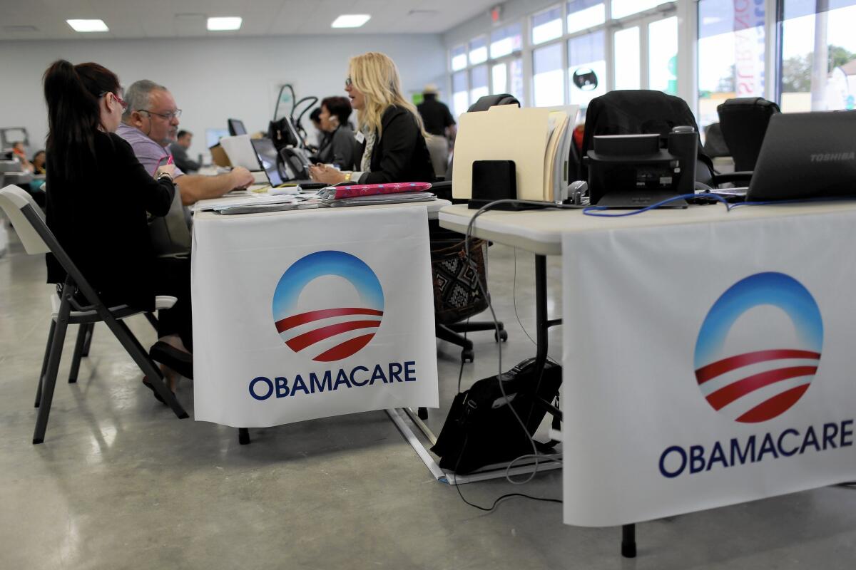 With tens of millions of Americans still uninsured, Obama administration officials and other proponents of the Affordable Care Act are scrambling to get as many people as possible into health plans before the Feb. 15 deadline. Above, an Obamacare sign-up station in Miami last week.