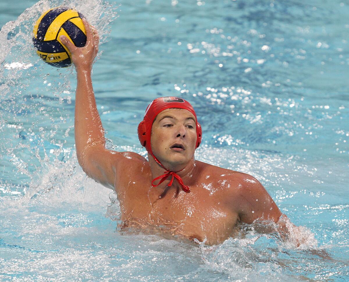 Glendale's Arman Momdzyan (10) fakes a shot and passes for an assist against Burbank in a Pacific League boys water polo first round playoff at Burbank High School on Tuesday, October 29, 2013.