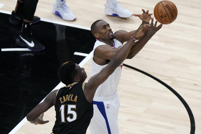 Los Angeles Clippers center Serge Ibaka (9) and Atlanta Hawks center Clint Capela (15) battle for a loose ball in the second half of an NBA basketball game Tuesday, Jan. 26, 2021, in Atlanta. (AP Photo/John Bazemore)